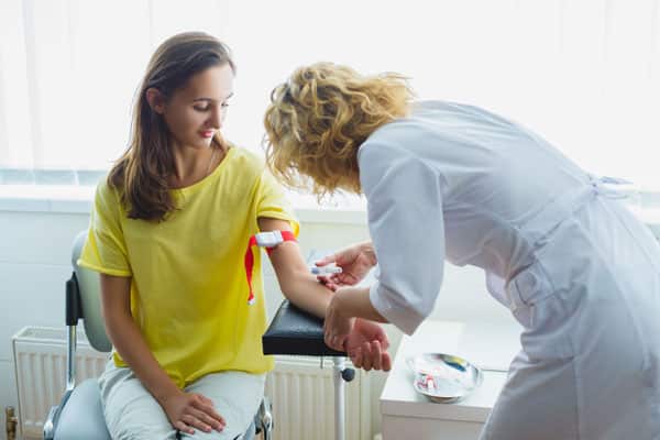 Nurse preparing to make an injection for blood taking.