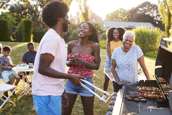 Couple laughing at a multi generation family barbecue
