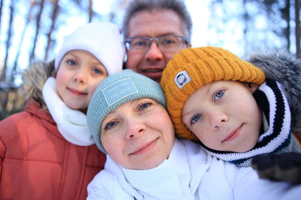 a family of four takes a selfie on the phone