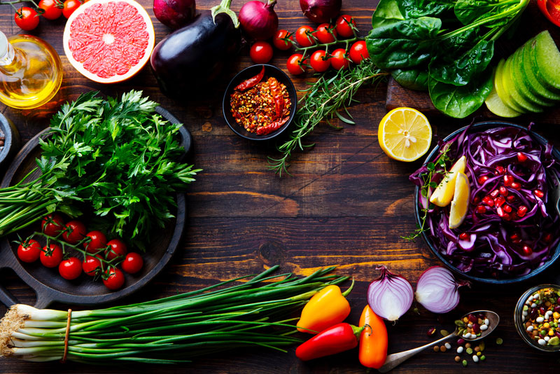 assortment of fresh raw vegetables on a wooden board