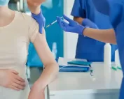 close-up of pregnant woman getting vaccinated