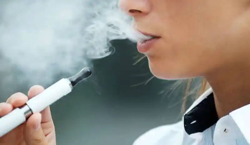 closeup of woman smoking electronic cigarette