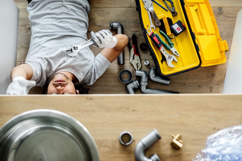 Man fixing kitchen sink