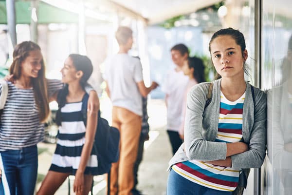 portrait of a lonely schoolgirl standing outside