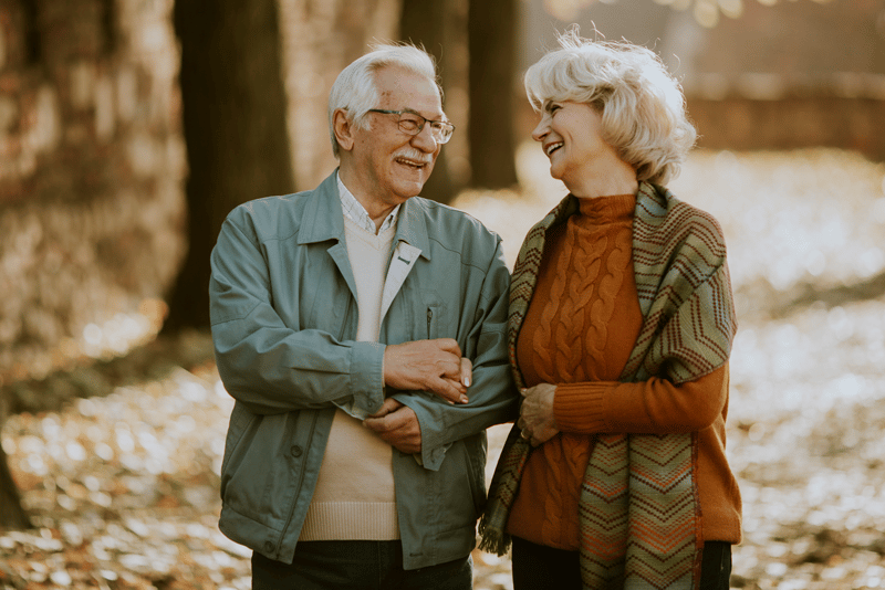 senior couple walking in autumn park