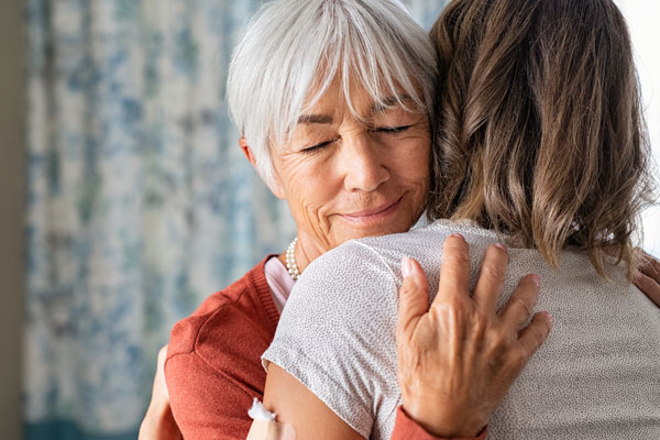 Adult Covid Vaccination Clinic senior woman embracing daughter after covid immunization