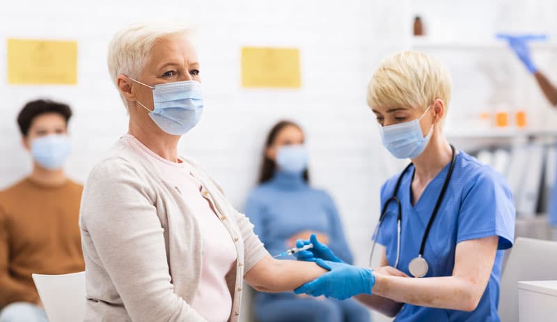 woman receiving covid-19 vaccine injection